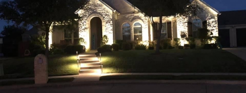 landscape lighting emphasizing the front of a house and the main walkway
